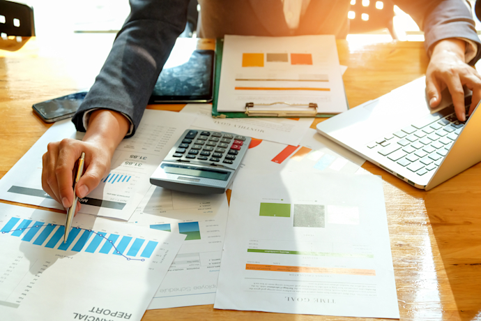 businessman-are-analyzing-graph-data-and-use-lapto-PJ7KJ7J