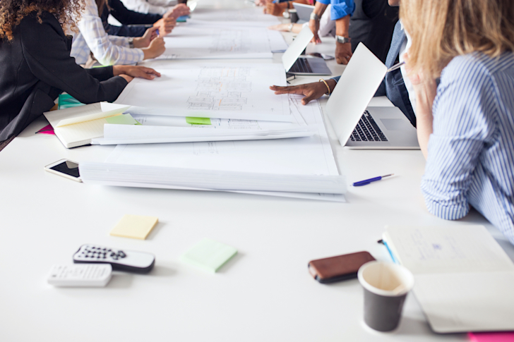 projects-and-files-on-conference-table-94WGLDN