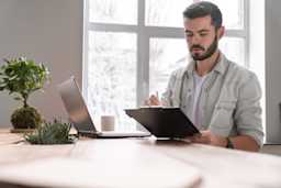 young-caucasian-businessman-making-notes-in-his-do-2022-01-29-00-00-52-utc