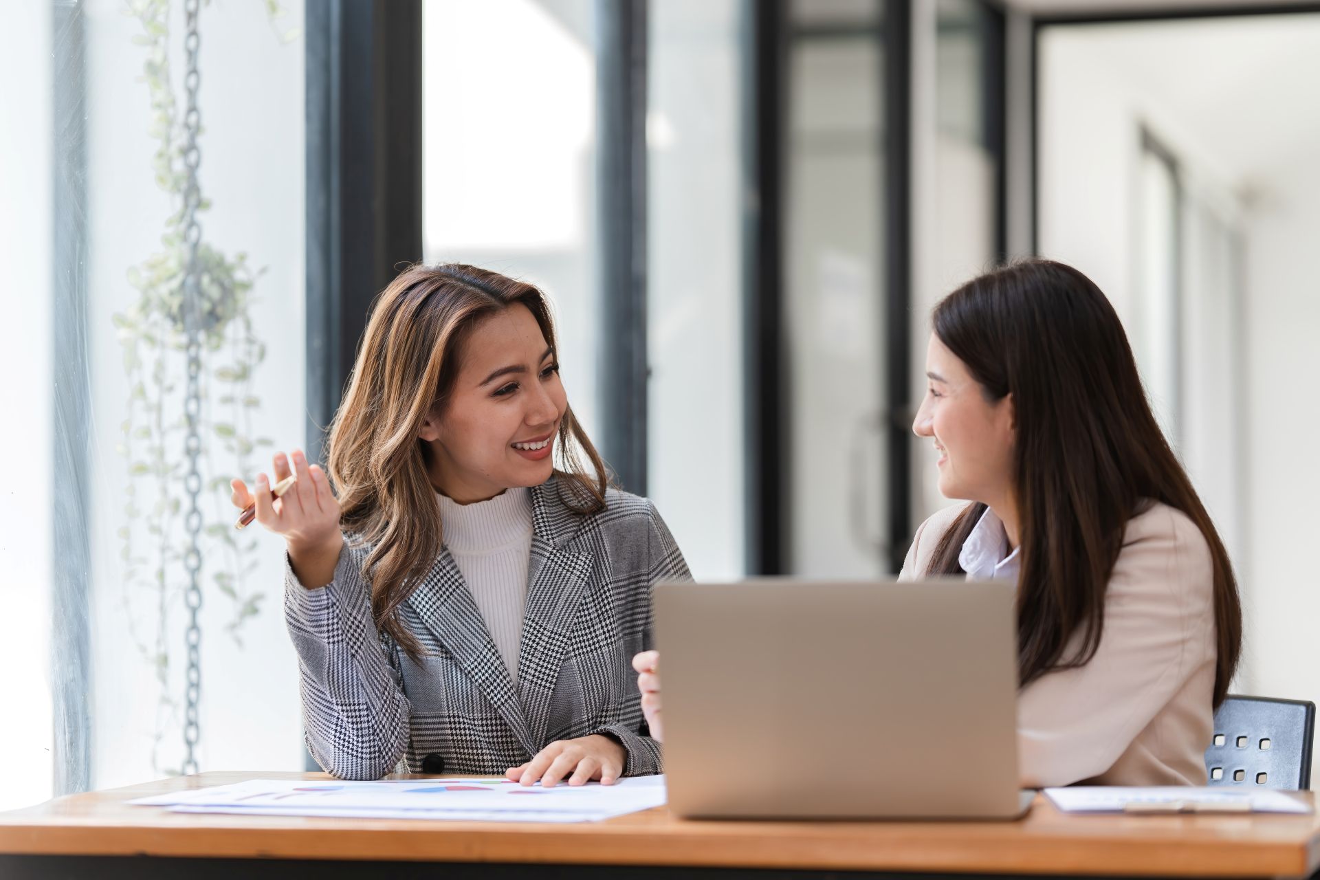 professionals-collaborate-on-laptop-in-modern-office