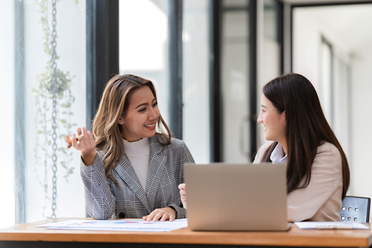 professionals-collaborate-on-laptop-in-modern-office